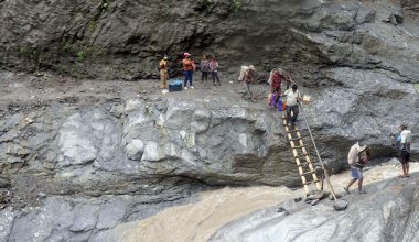 जोखिम मोलेर बाँसको भर्याङ्गबाट खाद्यान्न ओसारपसार (फोटो)